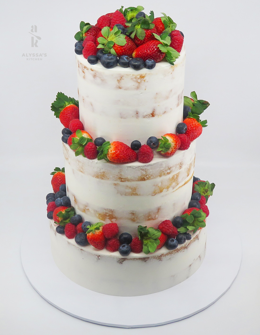 3 tier WCM with fruit Victoria Mendez 26.10.25 - Berry-Topped White Chocolate Mud Wedding Cake by Alyssa’s Kitchen